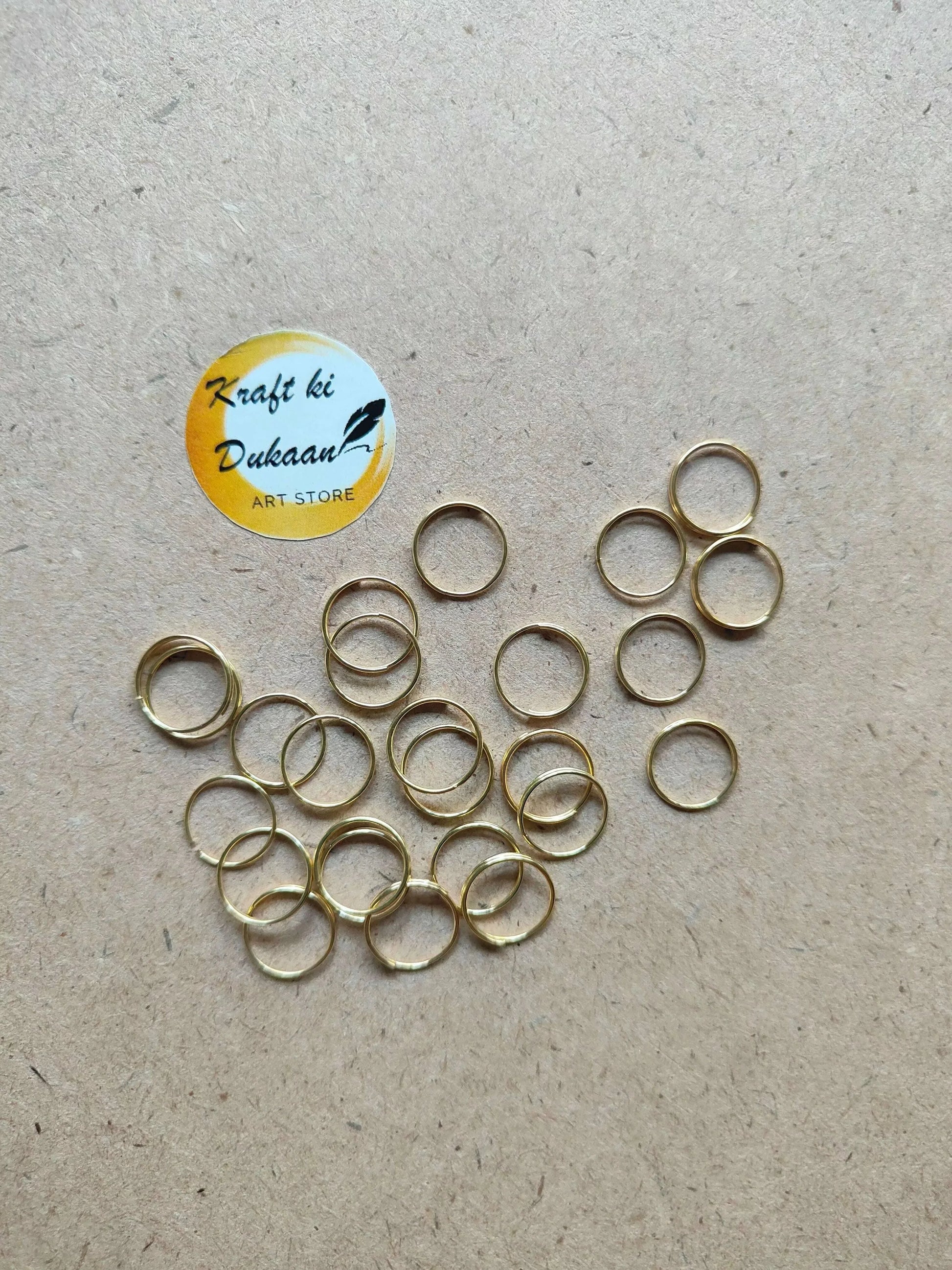 Assorted golden metal rings, circular hoops with open centers, grouped