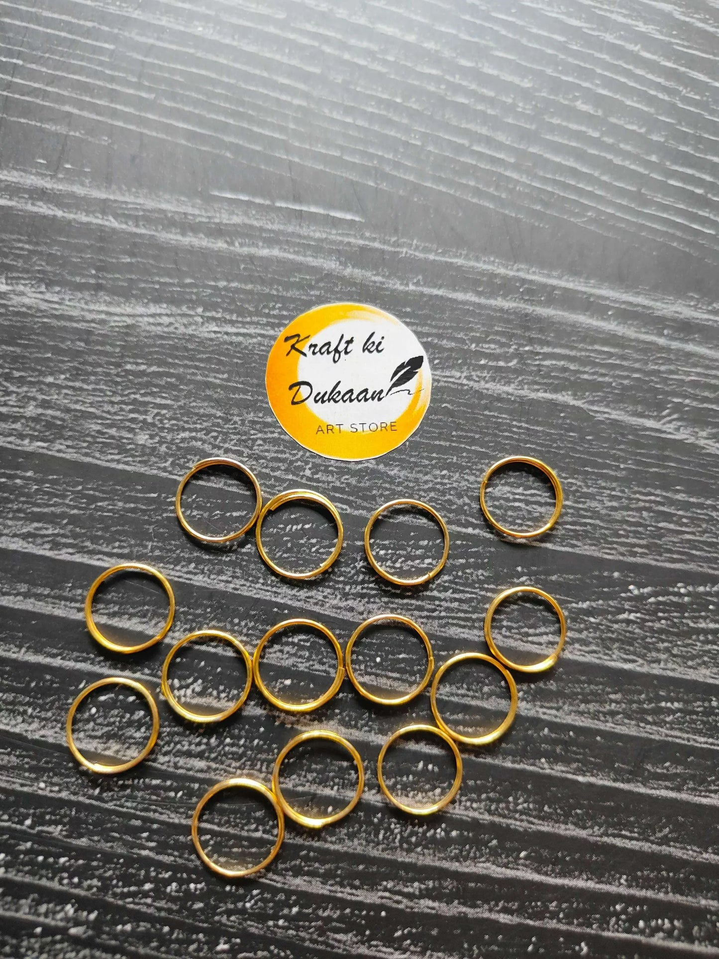 Golden metal circle rings with hollow centers, assorted sizes visible