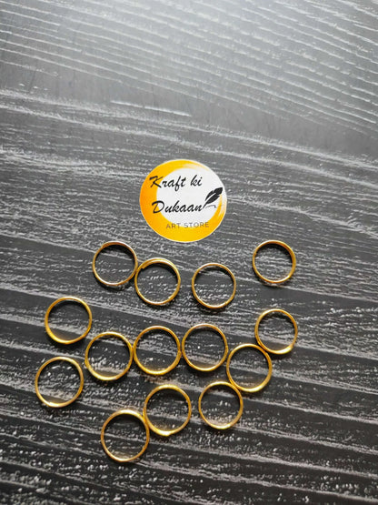 Golden metal circle rings with hollow centers, assorted sizes visible