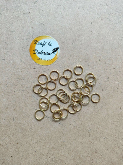 Golden metal ring hoops with open centers, mixed overlapping rings