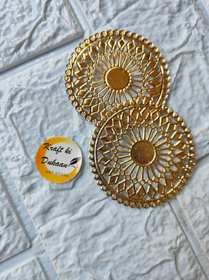 Two golden round t-light plates with ornate geometric cutout designs
