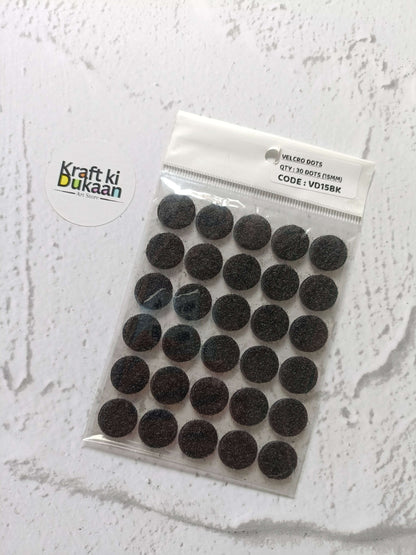 Black round Velcro dots set on backing card in clear sealed pack