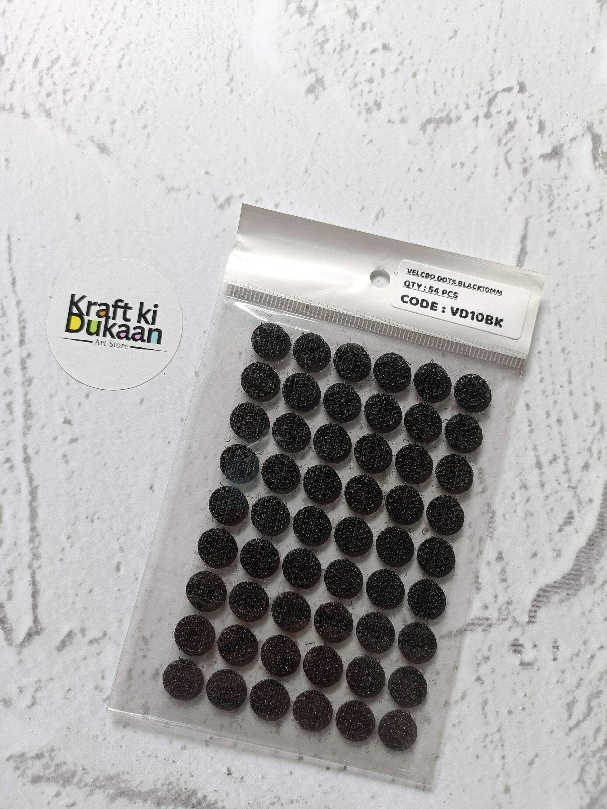 Black round self-adhesive Velcro dots on clear packet backing sheet