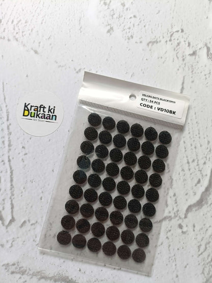 Black round self-adhesive Velcro dots on clear packet backing sheet