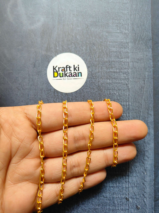 Gold tone jewellery chain with chunky rectangular links on hand
