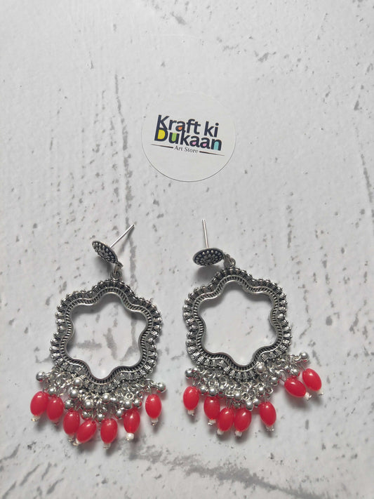 Traditional jhumka in silver with red beads, perfect for festive occasions or daily wear