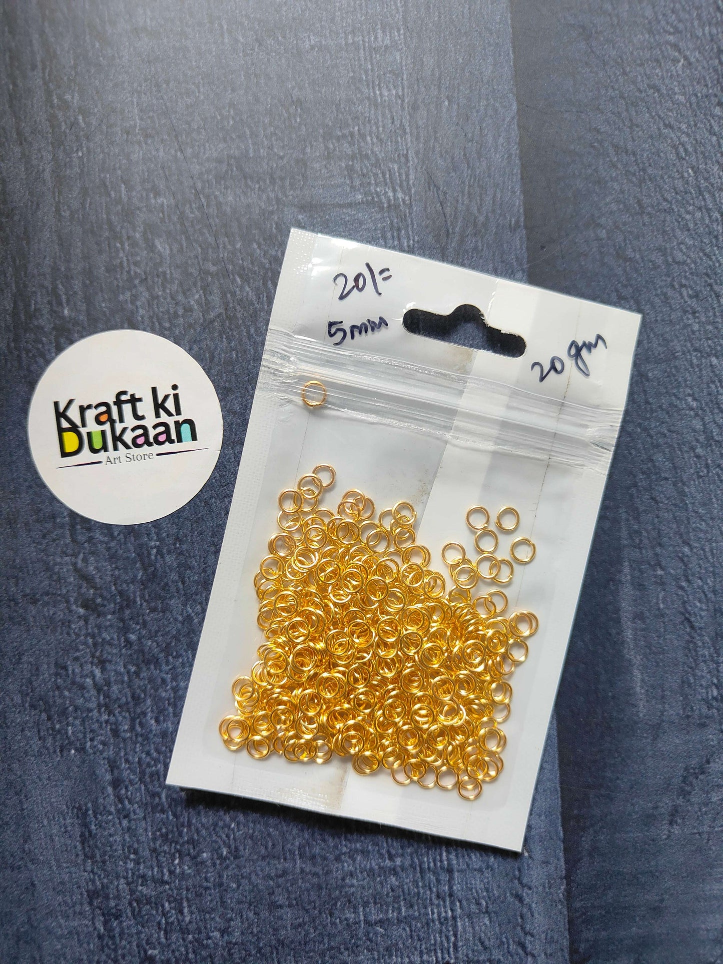 Golden jump rings, 20g pack with 5mm rings; scattered ring loops