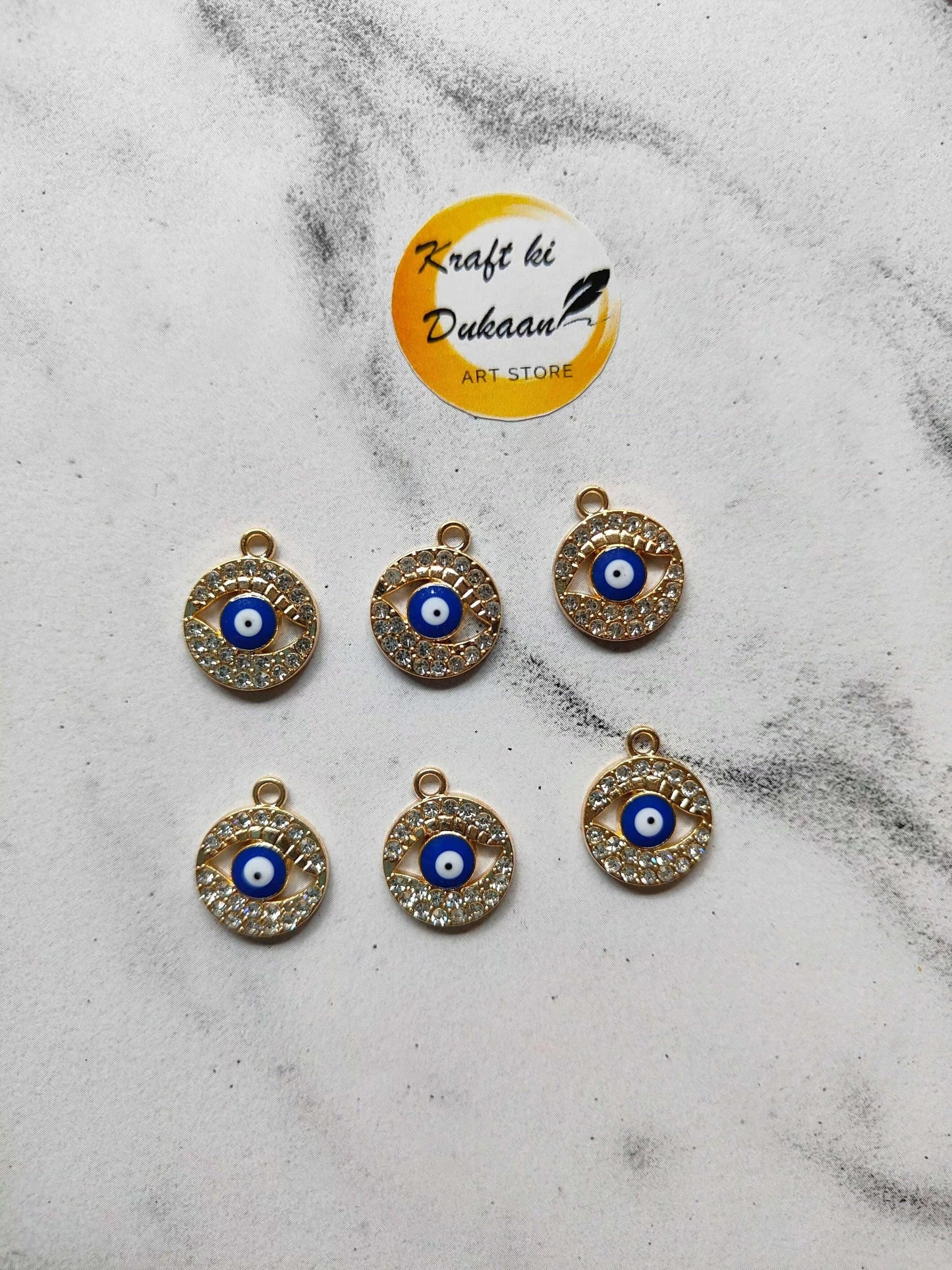 Assorted evil eye pendants with blue eye center and rhinestone edge, gold-tone loops