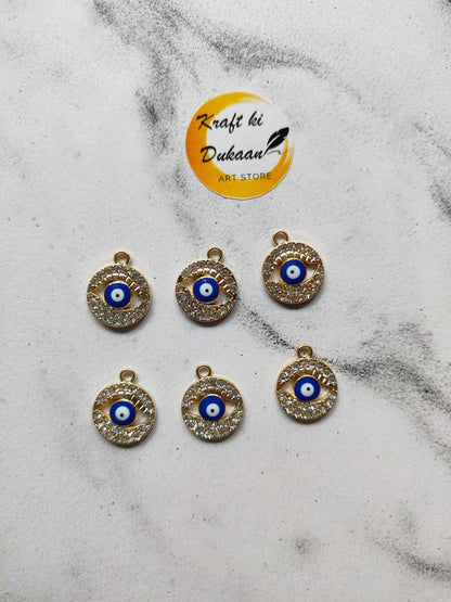Assorted evil eye pendants with blue eye center and rhinestone edge, gold-tone loops