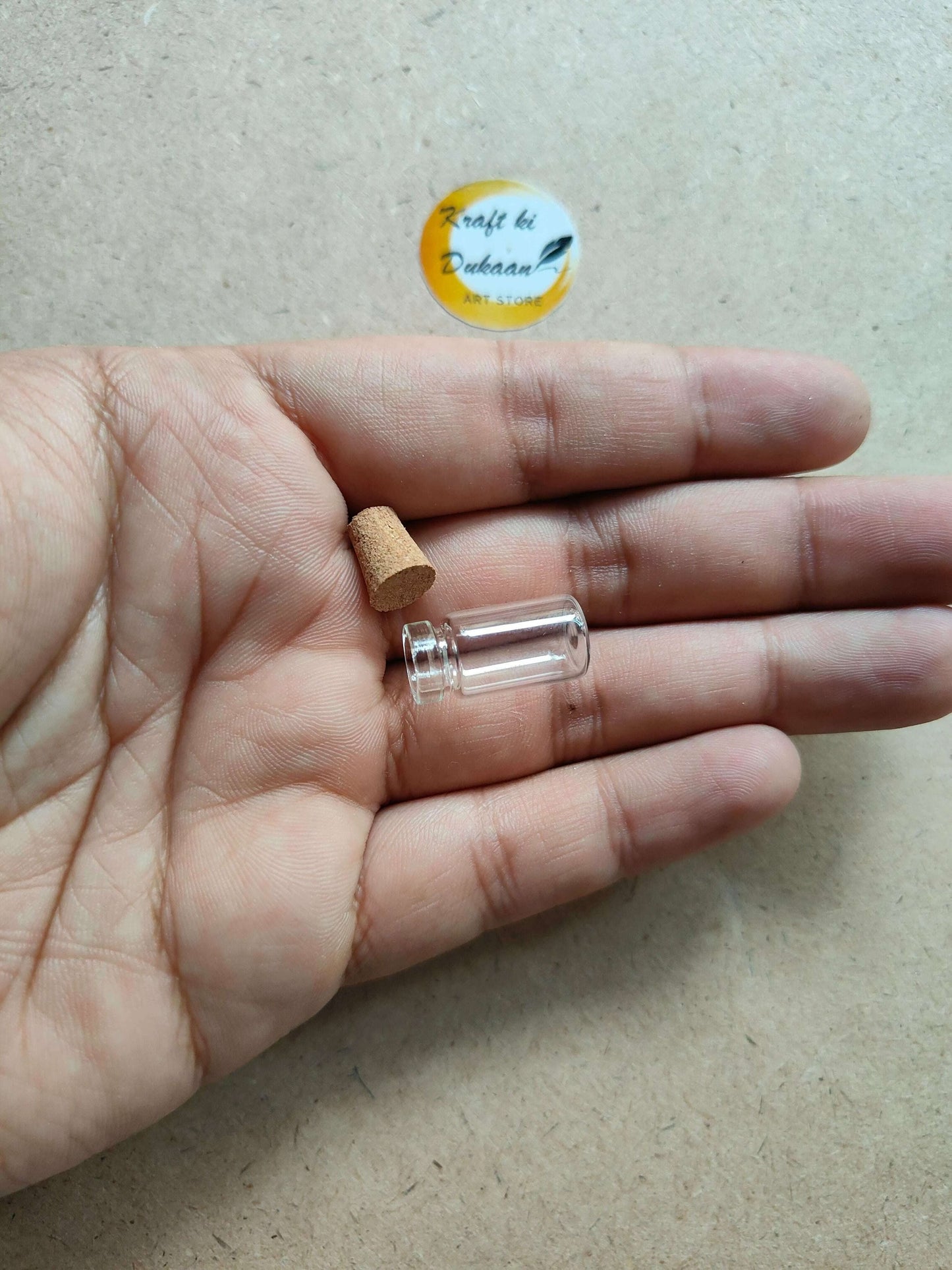 kraft-ki-dukaan-mini-glass-bottles-with-cork-pack-of-12-hand-holding-bottle