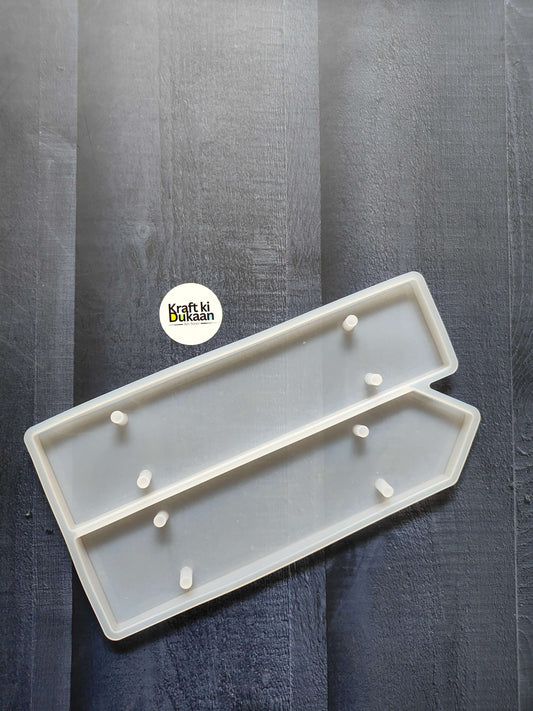 2-cavity name plate mould with white plastic tray and raised peg holders