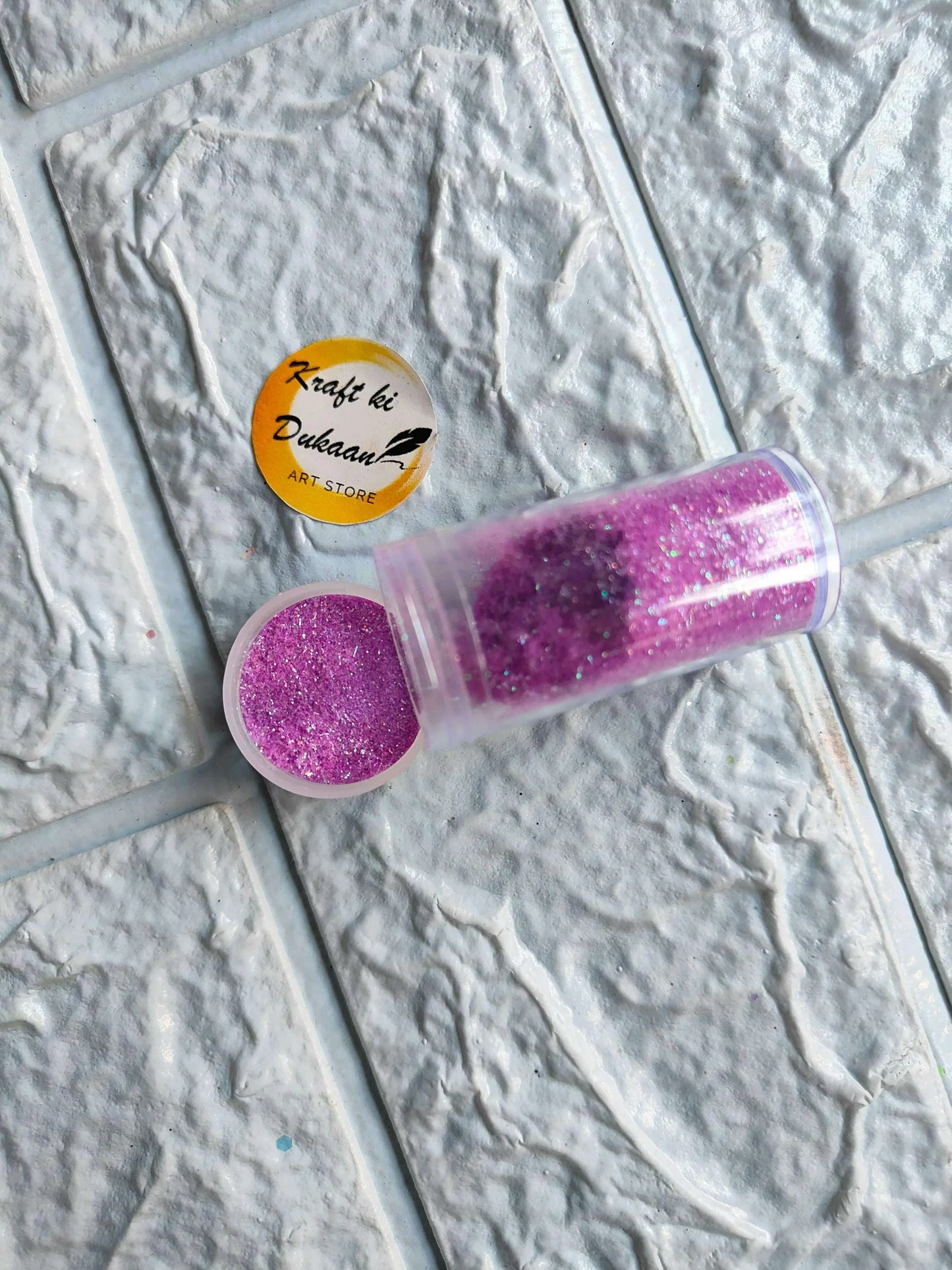 Neon glitter tube in violet purple with matching round glitter cap