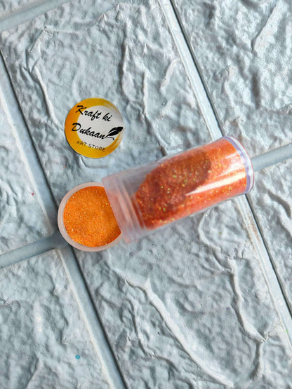Neon glitter tube in orange with matching round glitter cap