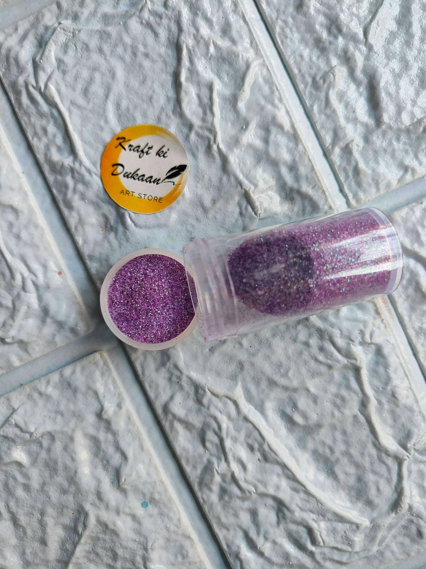 Neon glitter tube in purple with matching round glitter cap