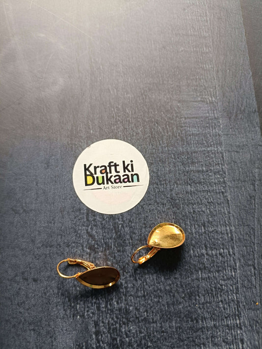 Gold-tone drop earring bases with oval settings: one dark brown, one golden yellow