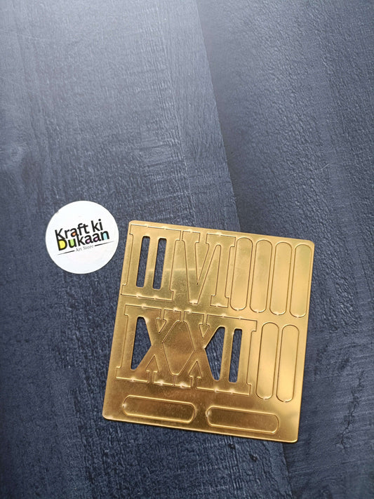 Golden acrylic Roman numerals and stick markers set on rectangular sheet