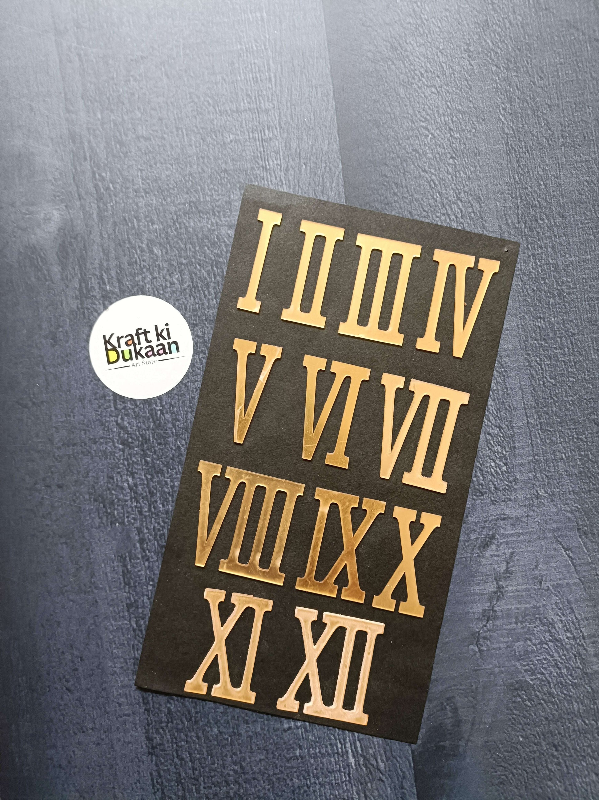 Gold acrylic Roman numeral stickers on dark backing, set of I–XII