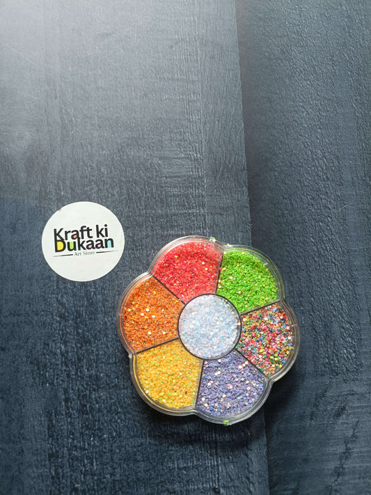 Round glitter box with eight colored glitter compartments—red, green, yellow and more