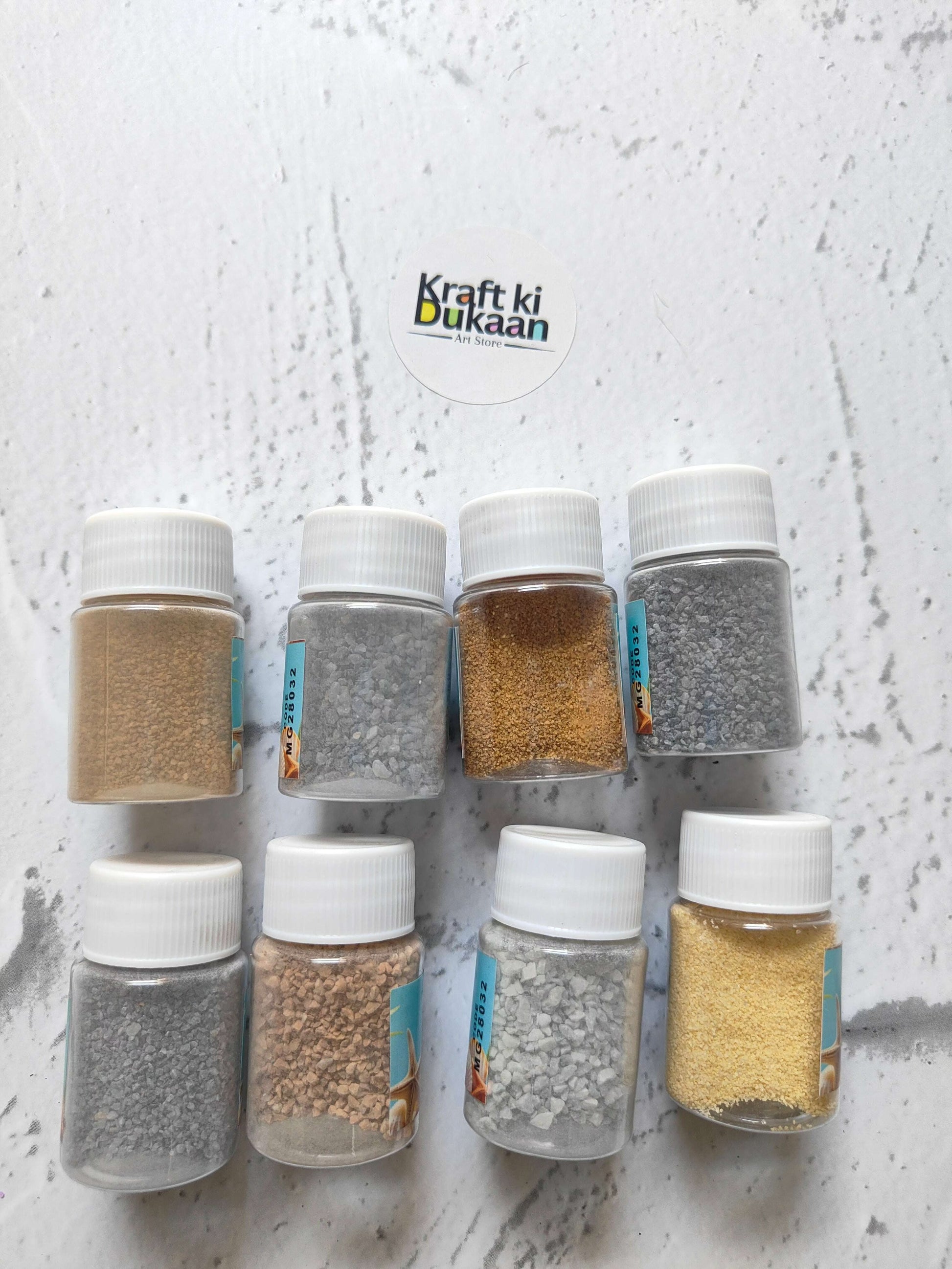 Colored granules sand pack of 8 with jars of beige, brown, and gray granules