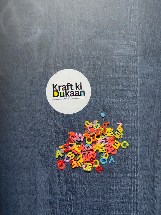 Alphabet Sequin packs, 5mm multicolor letters scattered on fabric