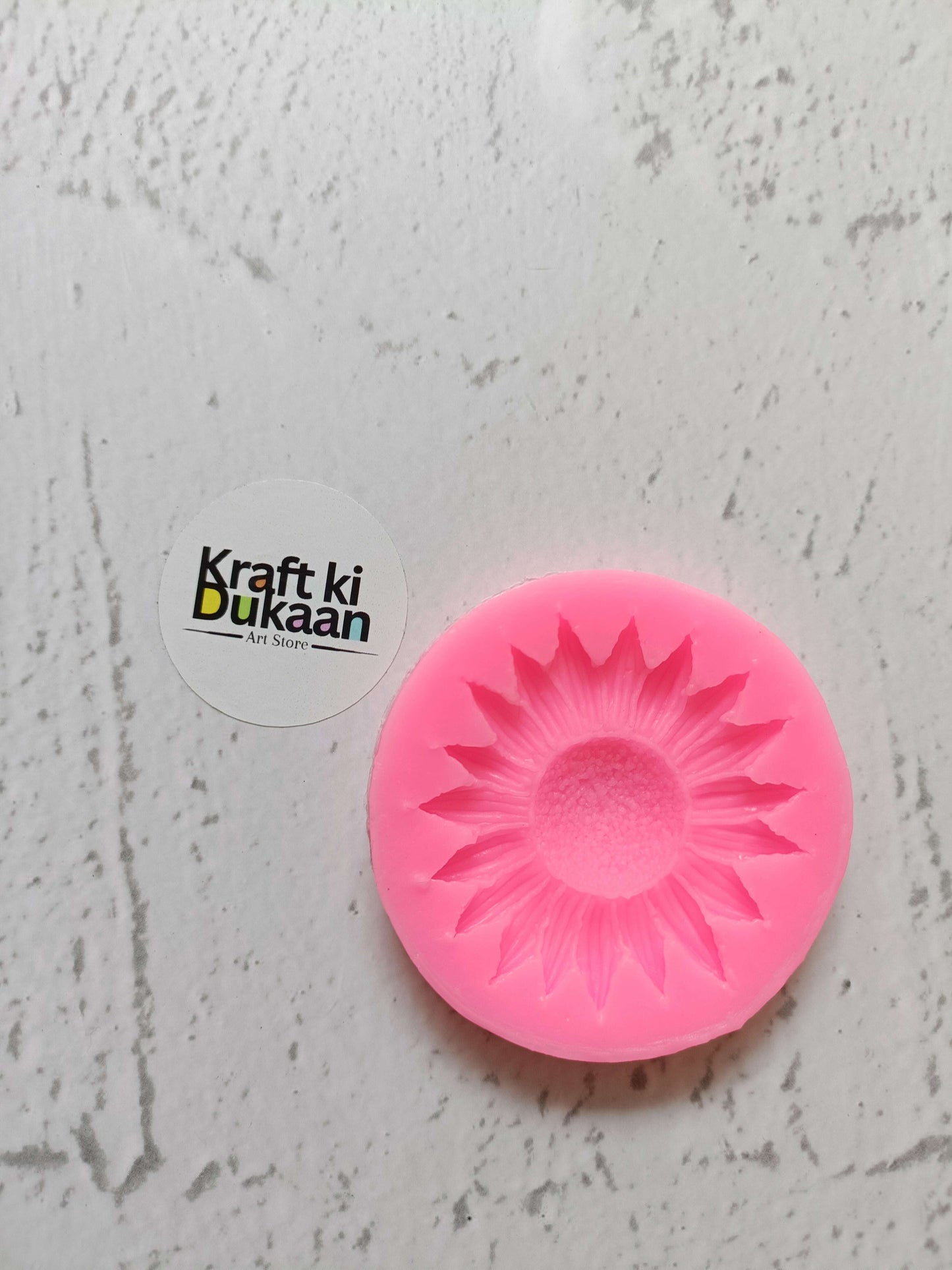Pink sunflower mould with raised petal design, round silicone form