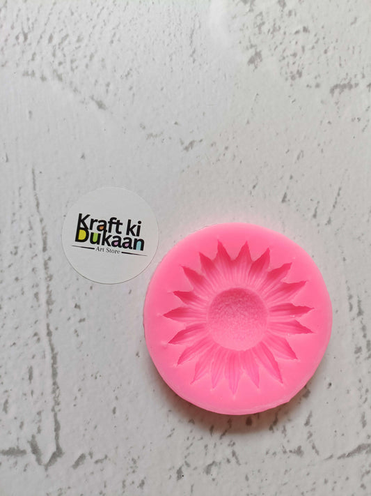 Pink sunflower mould with raised petal design, round silicone form