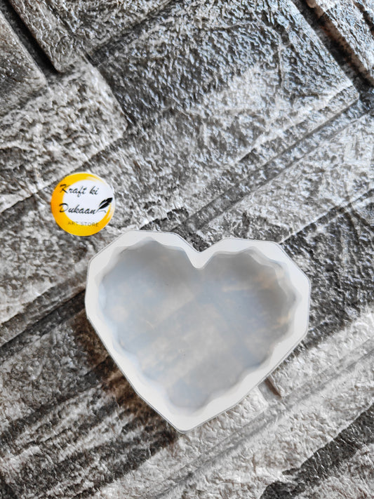 White 3 inch heart silicone mold from Kraft ki Dukaan on a textured gray surface