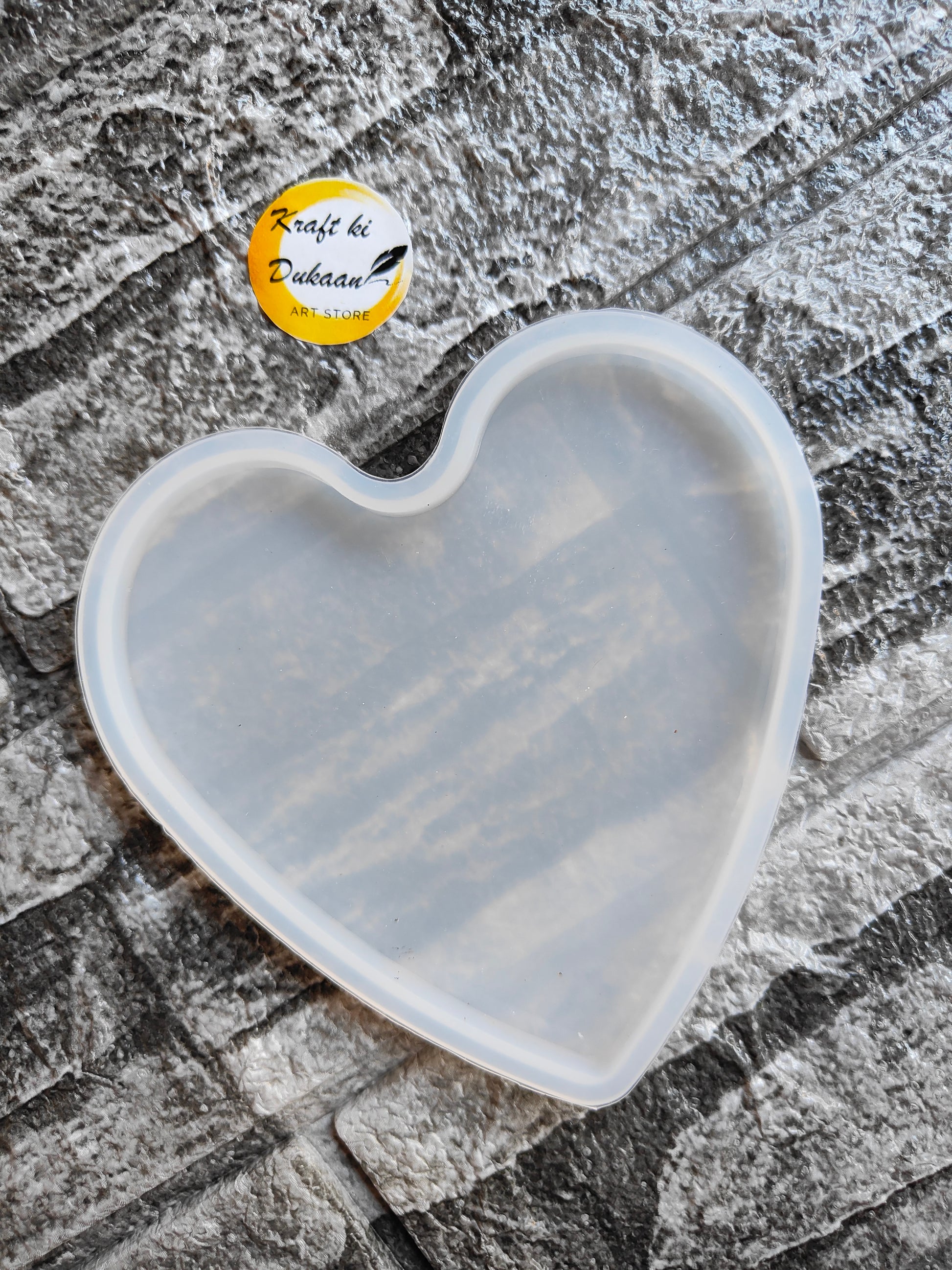 Transparent 4 inch heart silicone mold by Kraft ki Dukaan on textured background