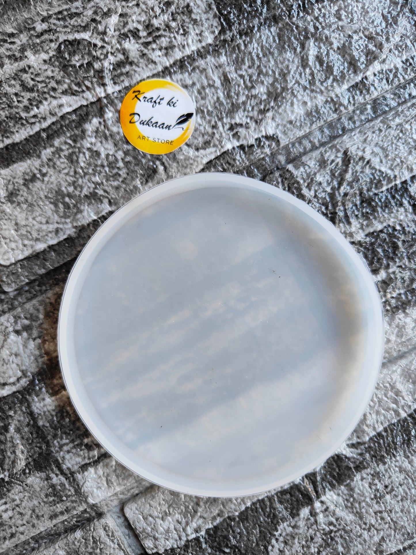Kraft ki Dukaan 4 inch resin coaster mould in round shape on textured surface