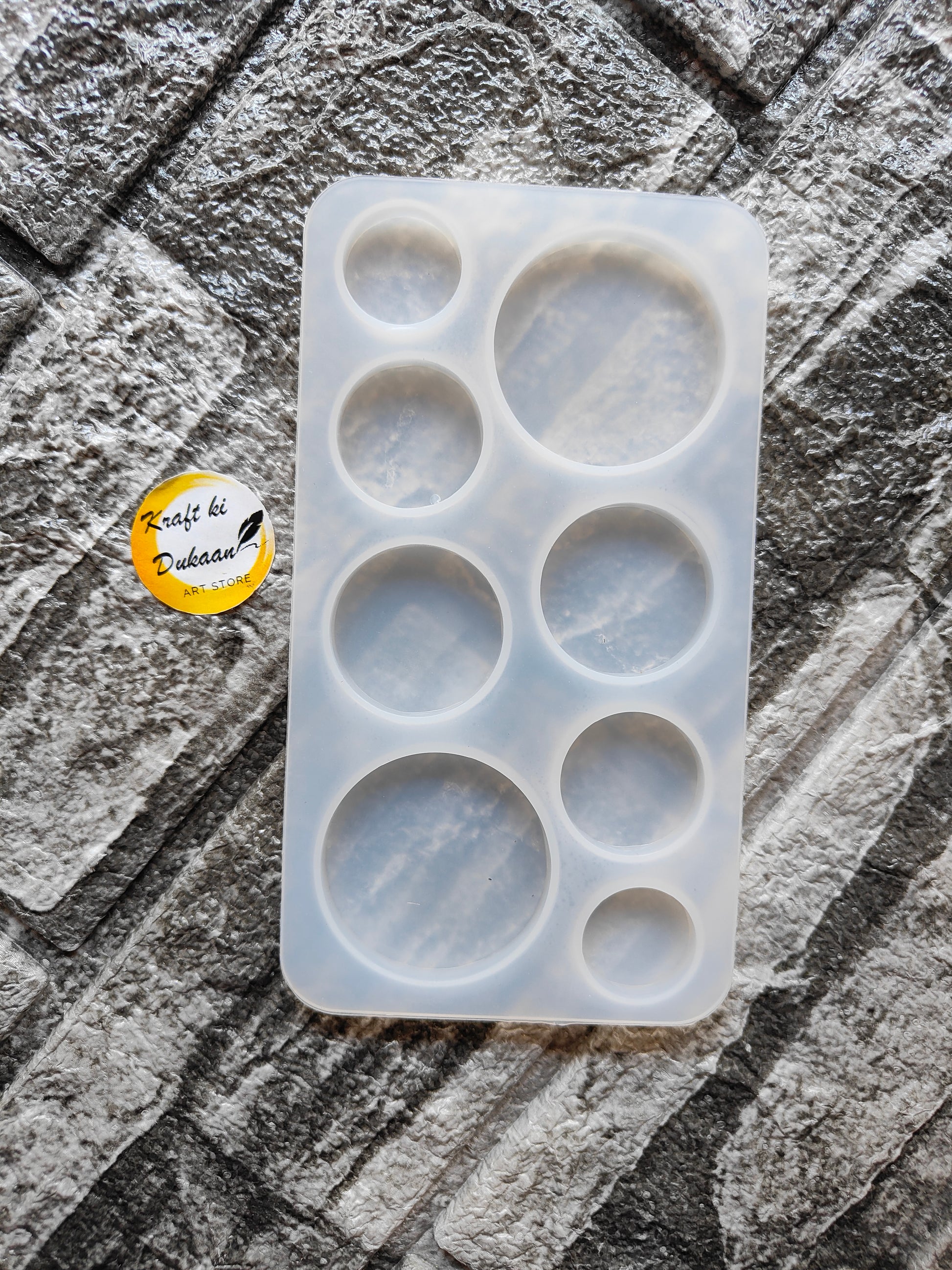 8 cavity silicone mold for resin by Kraft ki Dukaan with various circular shapes on textured surface