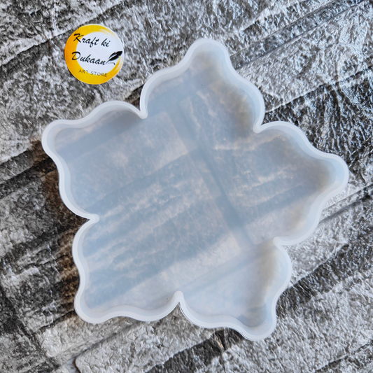 Transparent flower coaster mould for resin from Kraft ki Dukaan on textured surface