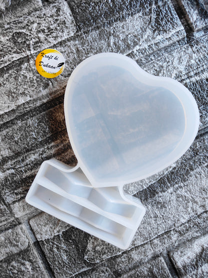 Heart shaped resin frame mould from Kraft ki Dukaan on textured surface for crafting projects