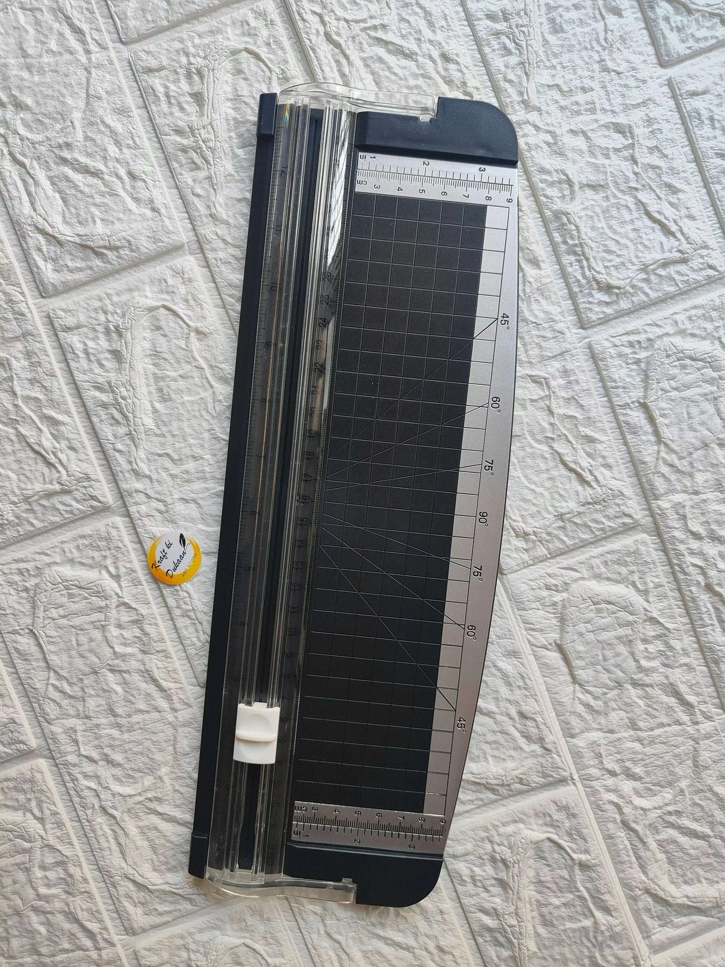 Big paper cutter trimmer with dark grid base and ruler scale in a clear frame