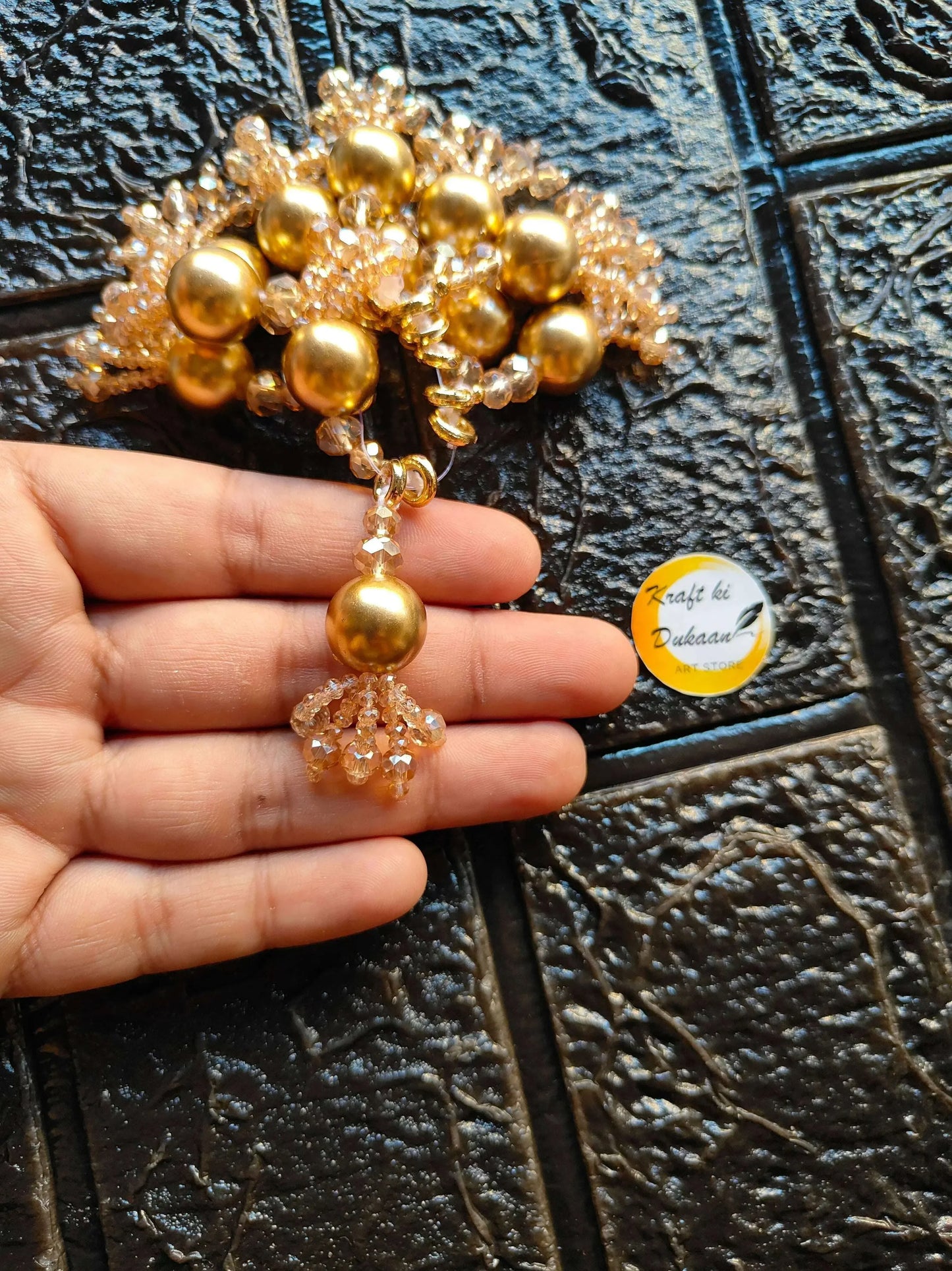 Gold bead-and-floral latkan with round ball center and chandelier-style bottom