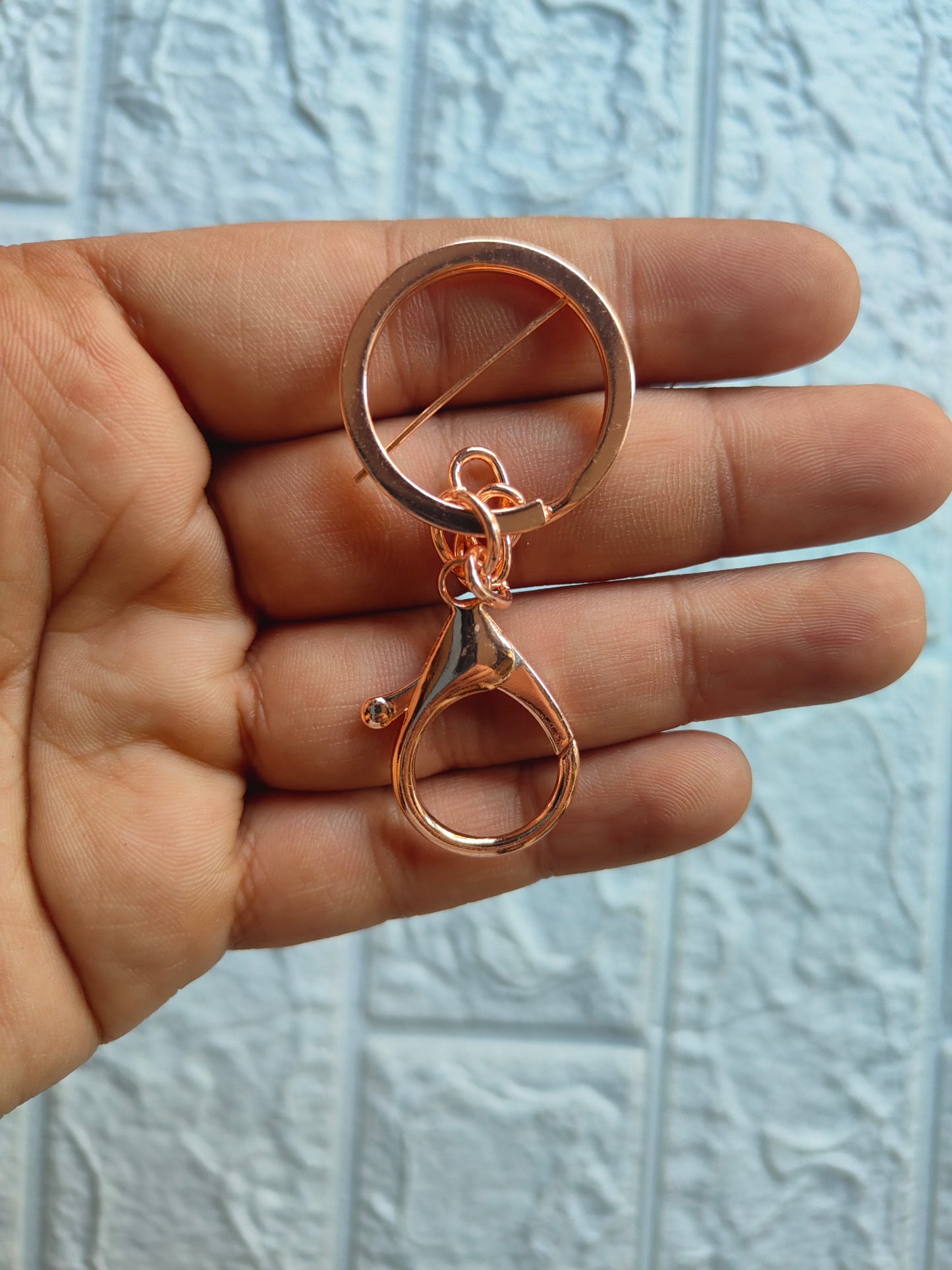 Chic lobster clasp keychain in rose gold finish attached to a metal ring for easy access