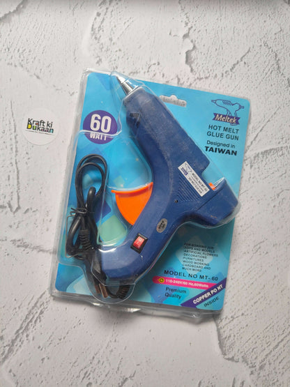 Hot melt glue gun blister pack, dark blue body with orange front and black power cord.