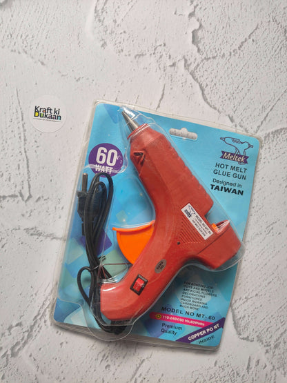 Hot melt glue gun blister pack, red body with orange front and black power cord.