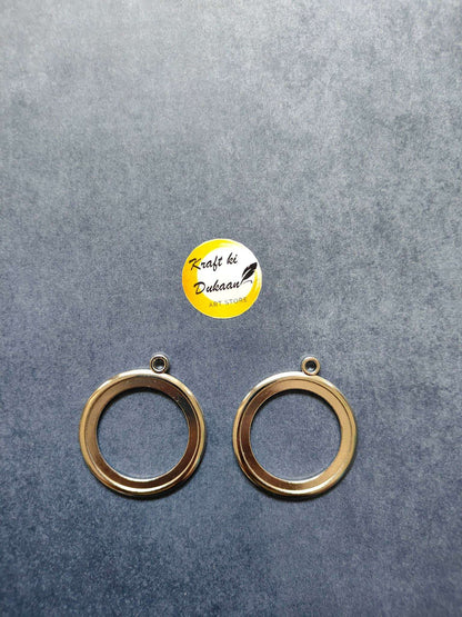 Round thick bezel set in silver-tone: 2 circular rings with top loops