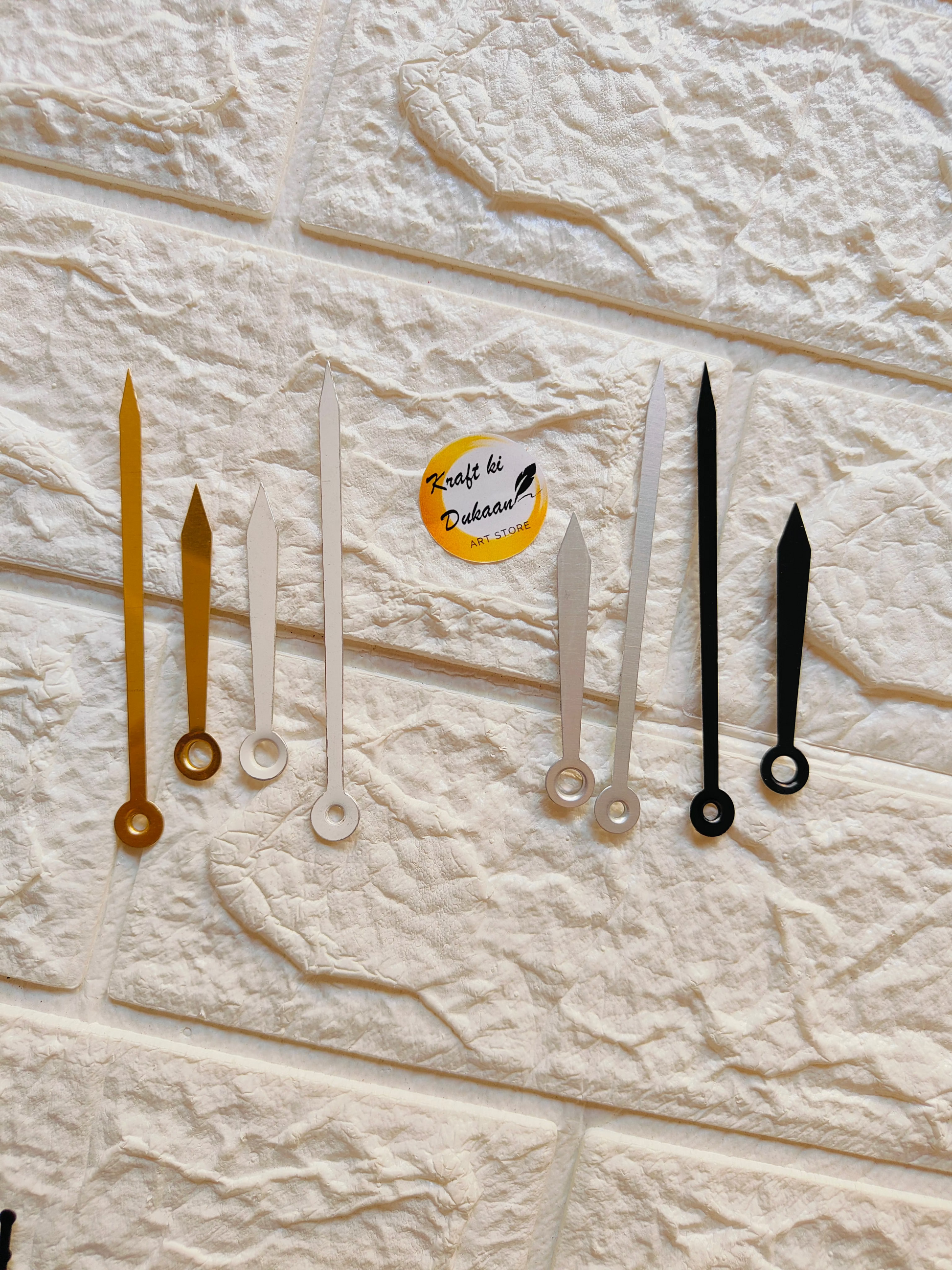 Various metal clock hands for crafts in gold, silver, and black colors for DIY projects