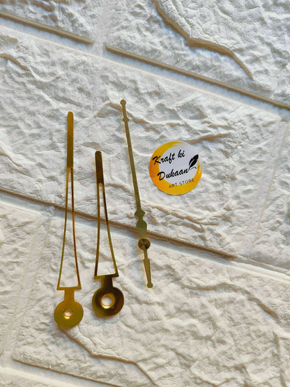 Metal clock hands set in gold finish, three long hands