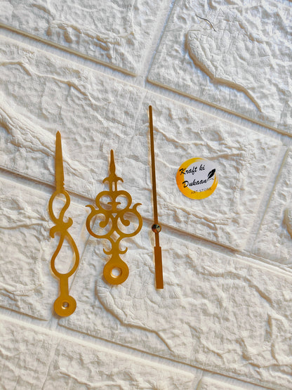 Gold metal clock hands for crafts with ornate designs for artistic DIY projects