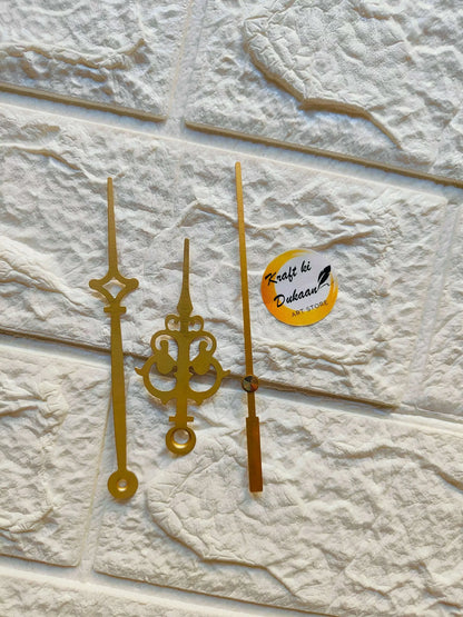 Gold metal clock hands set with ornate center and three slender minute hands