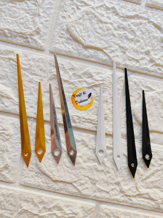 Variety of metal clock hands for crafts in different colors including gold, silver, white, and black