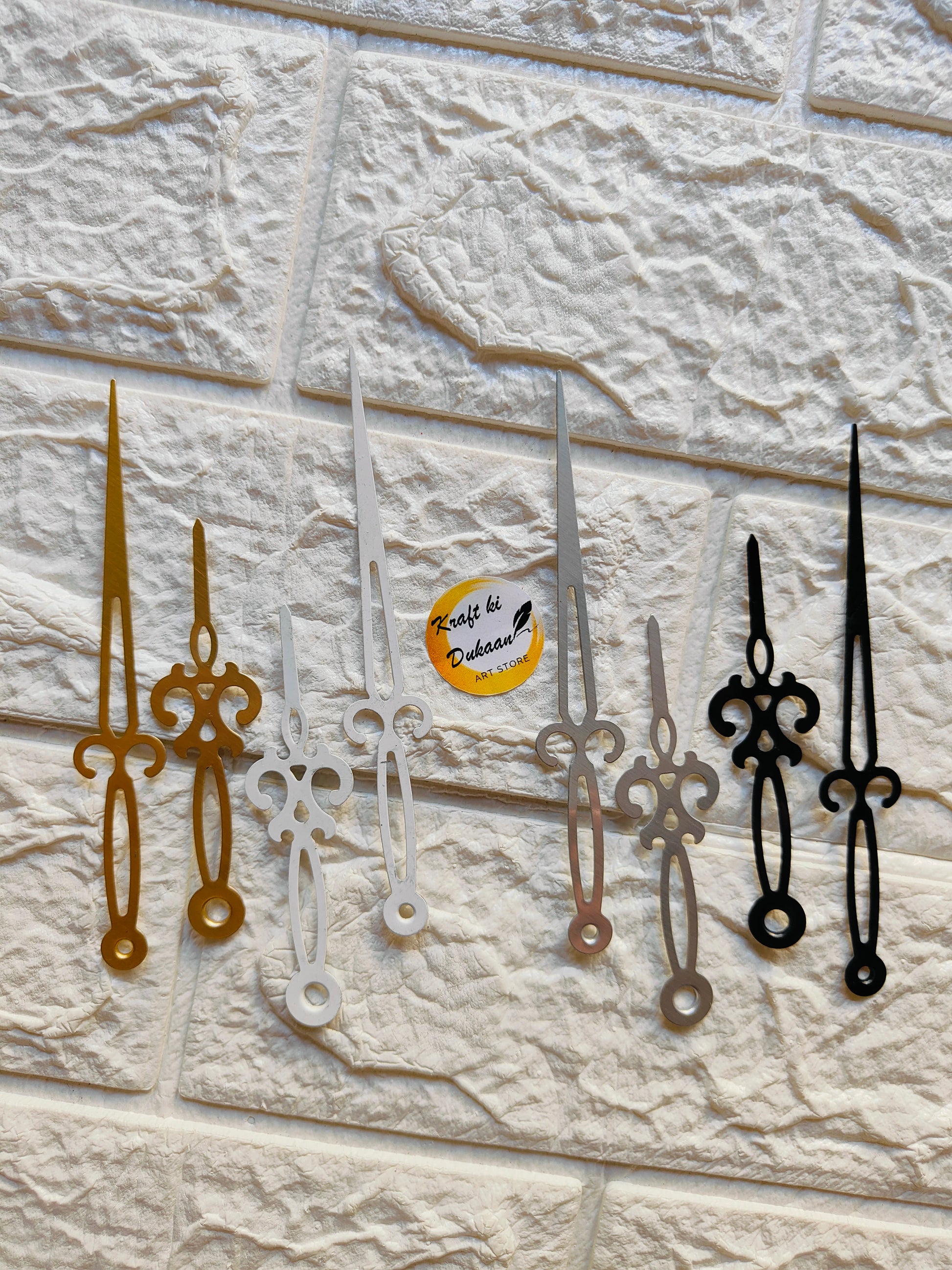 Variety of metal clock hands for crafts in gold, silver, and black for DIY projects