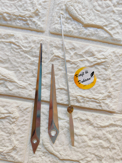 Three metal clock hands for crafts featuring a bronze finish and sleek design for DIY projects