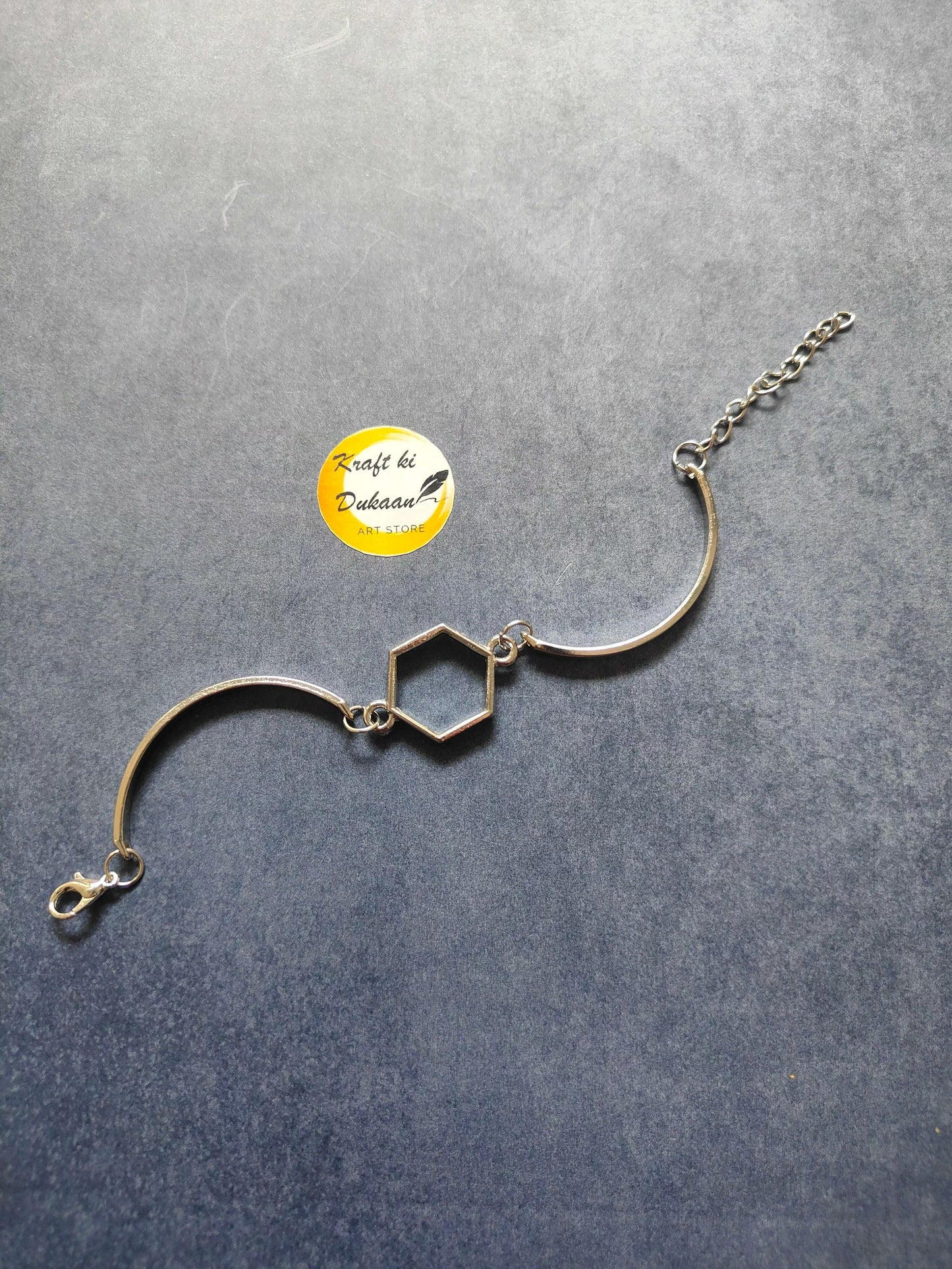 Silver metal bracelet with hexagon charm links and lobster clasp