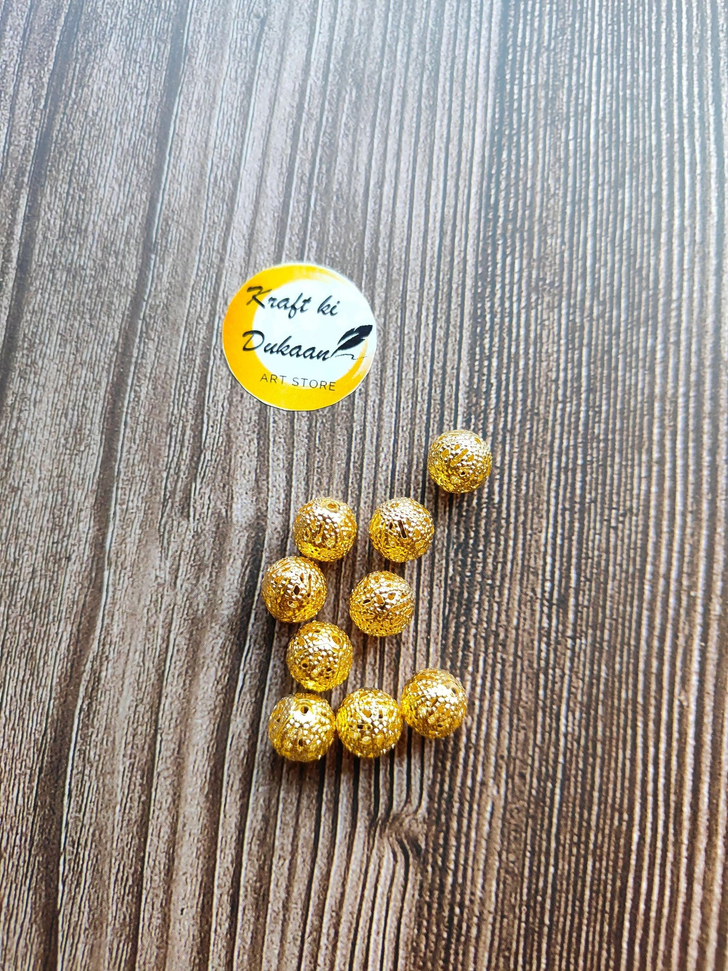 metal-jali-craft-balls-gold-bead-set-on-wood