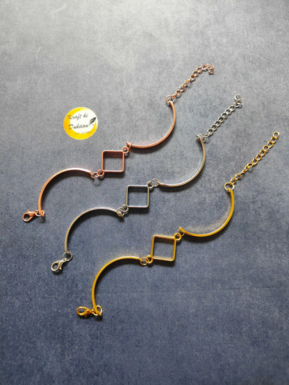 Rose gold metal bracelet with curved bar and square link charms, chain with clasp