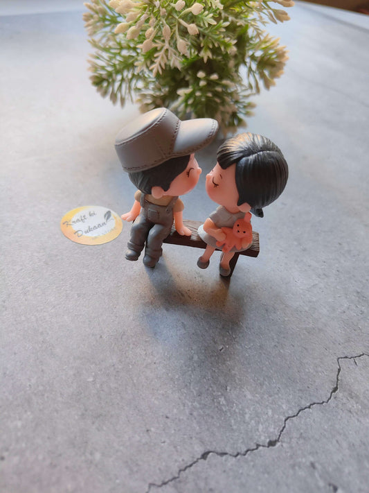 miniature-couple-figurine-kissing-on-bench