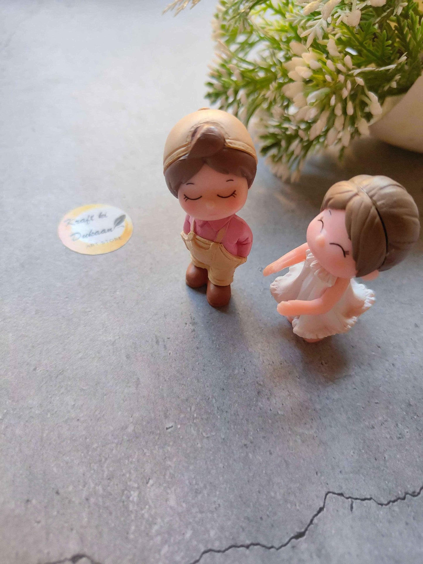 Miniature Model A4: two child figurines, one pink shirt, one white dress.